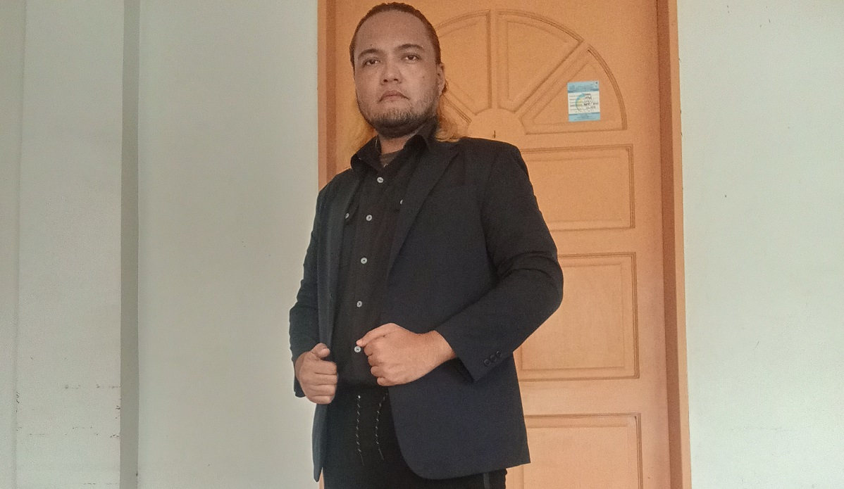 An adult Filipino male wearing business casual attire with a Uniqlo Navy Blazer.