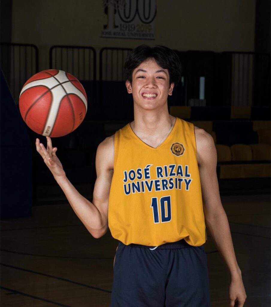 Franchesko Capistrano was playing for Jose Rizal University. He is wearing a yellow jersey with a number 10. In the photo, he is seen spinning the ball.