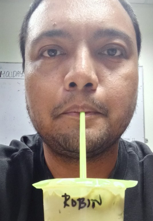 Robin drinking his Matcha Latte in the office.